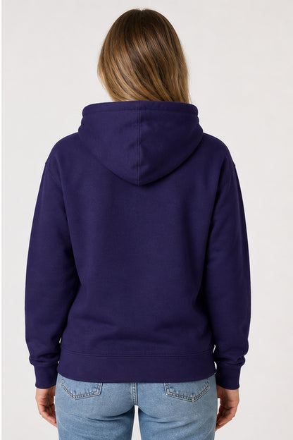 A woman viewed from the back wearing a solid dark purple hoodie and light blue jeans against a plain light gray background.