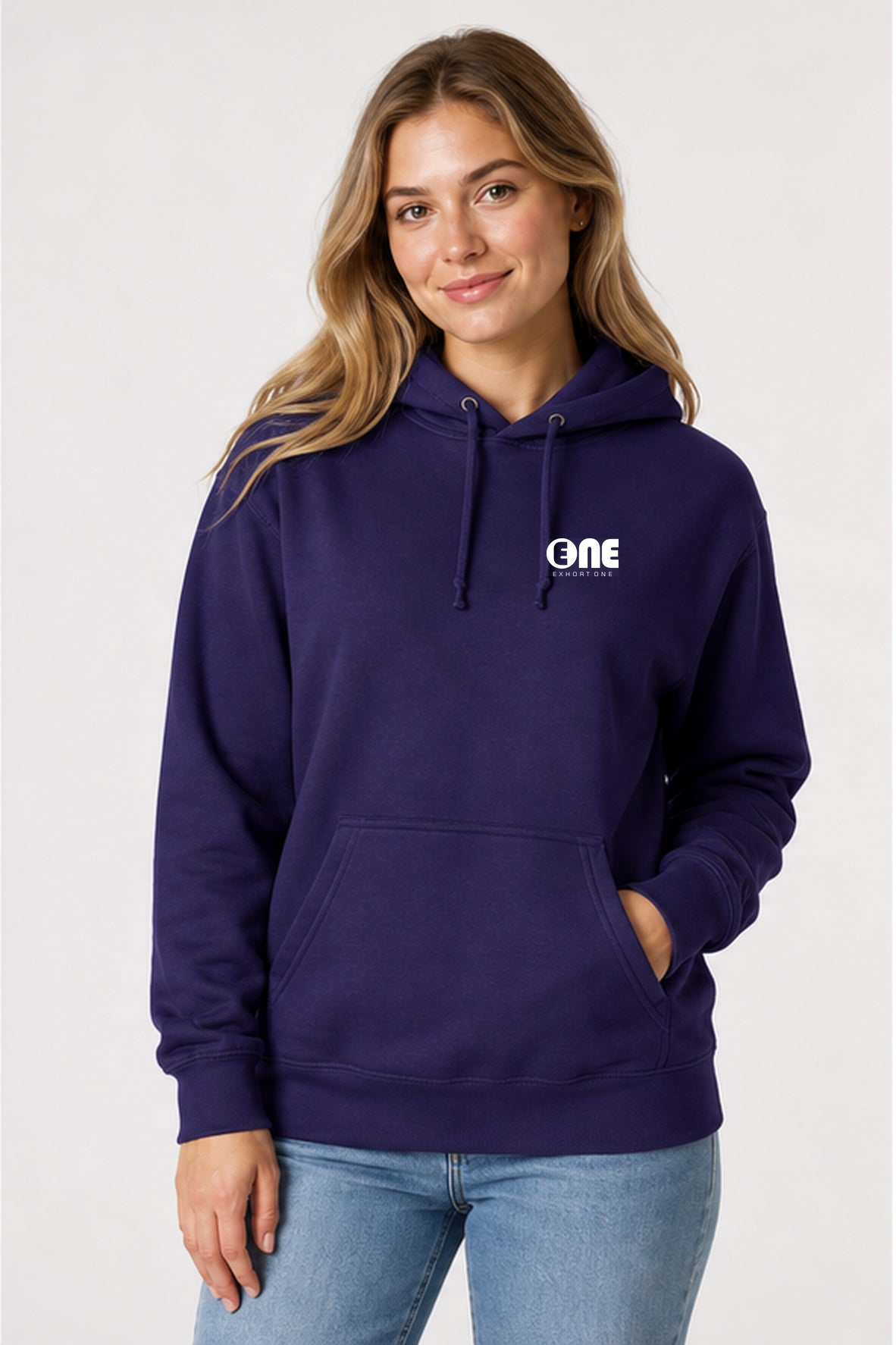 A woman wearing a dark purple pullover hoodie with a white 'ONE' logo on the left chest, paired with light blue jeans, photographed against a light gray studio background.